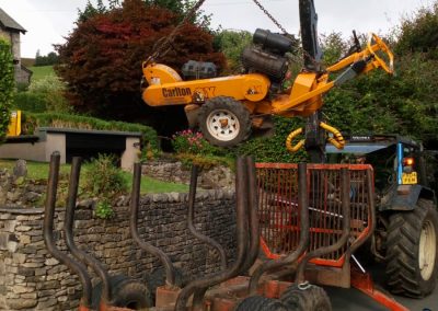 A Lumber Tree care crane lifting our tree stump removal tool
